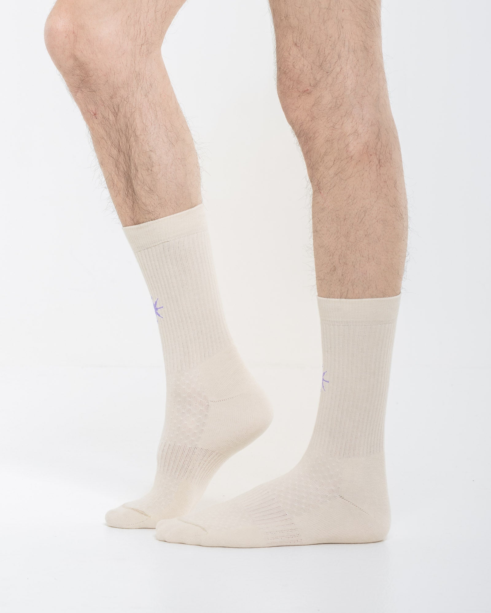 Cardo Radura Apex Half Calf socks in ecru, side view on a model against a white background.