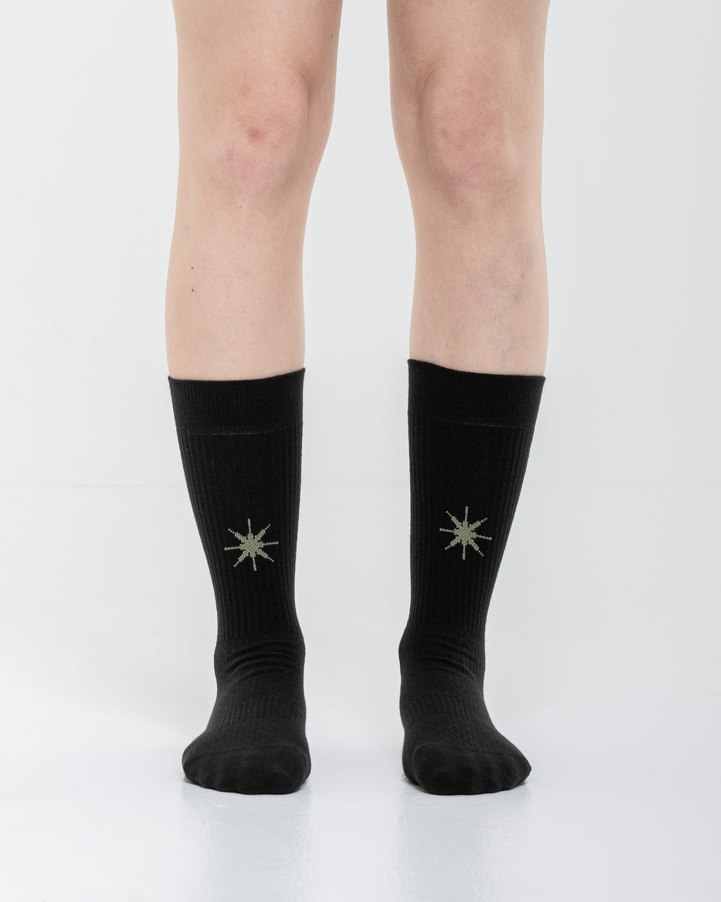Cardo Radura Apex Half Calf socks in black, front view showing the embroidered star detail.