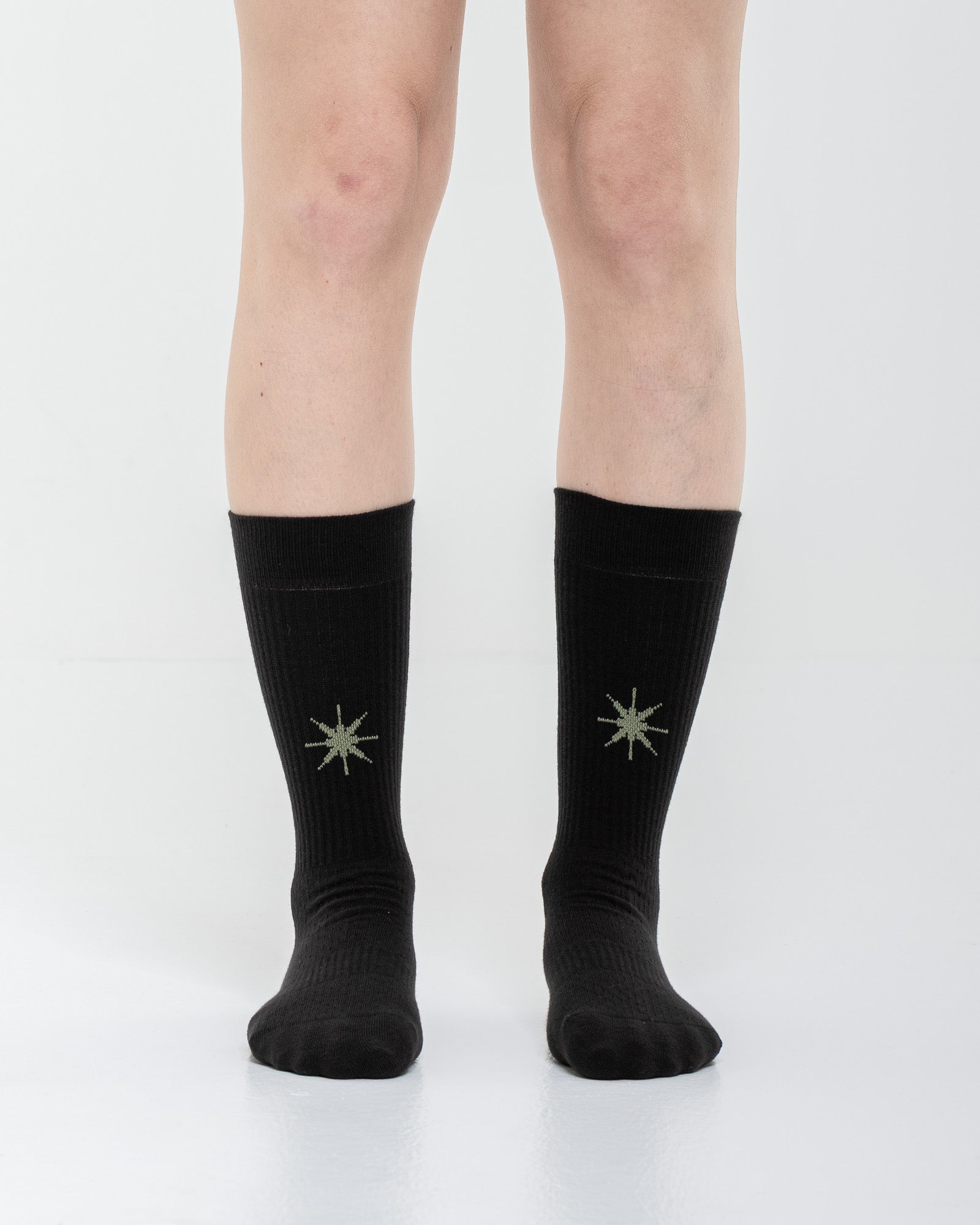 Cardo Radura Apex Half Calf socks in black, front view showing the embroidered star detail.