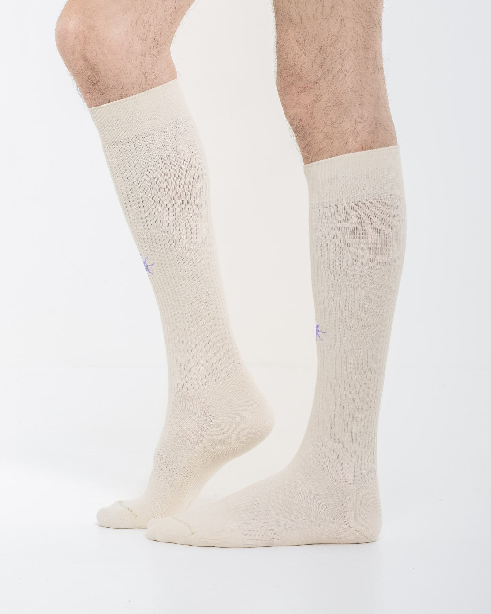 Cardo Radura Apex Knee High socks in ecru, side view on a model against a white background.