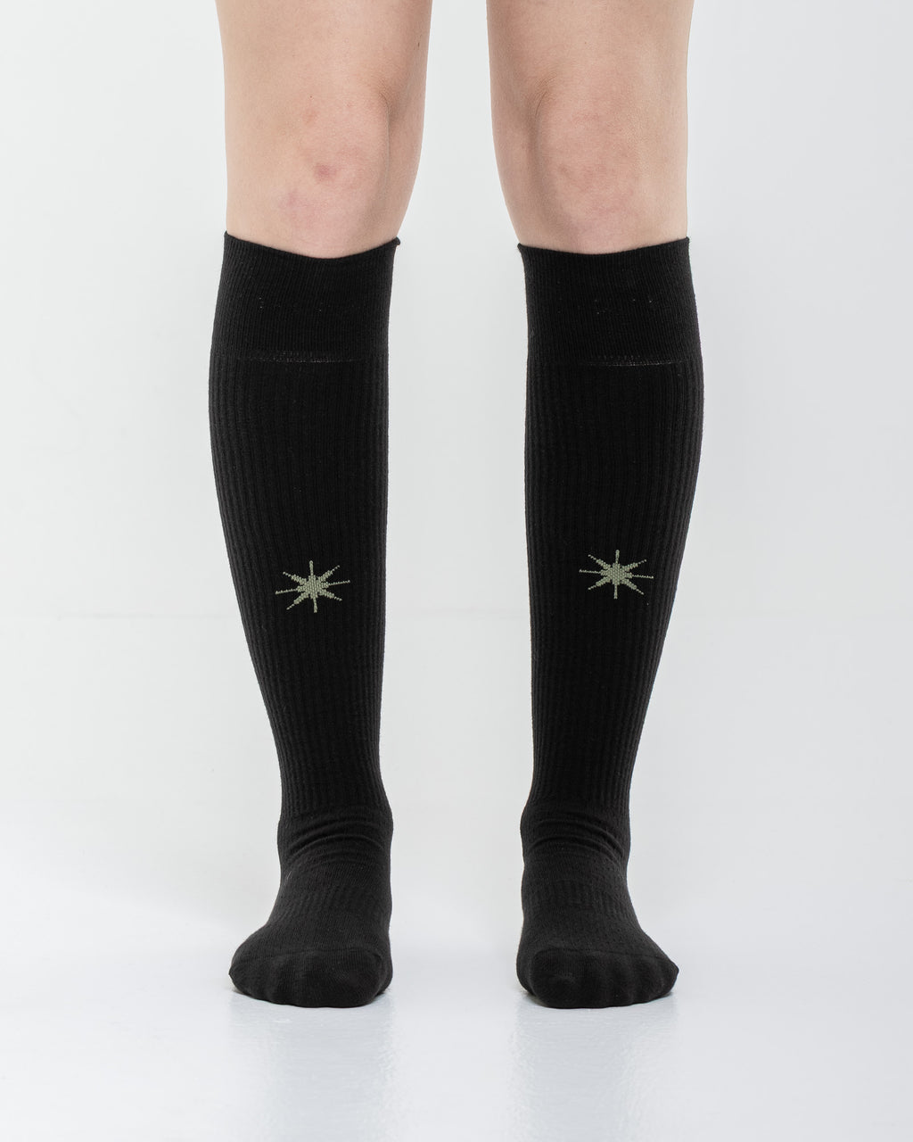 Cardo Radura Apex Knee High socks in black, front view showing the embroidered star detail.