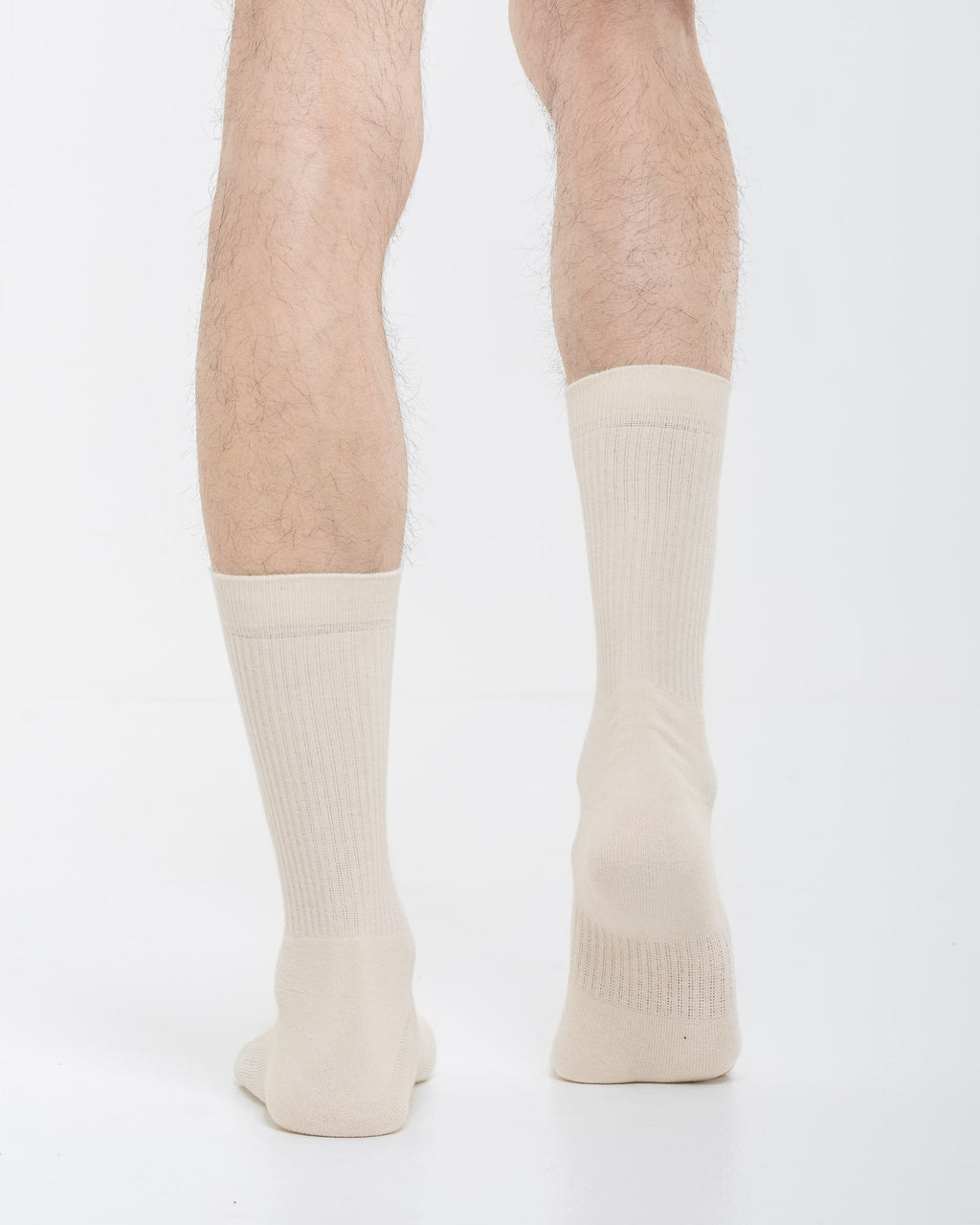 Cardo Radura Apex Half Calf socks in ecru, rear view on a model against a white background.