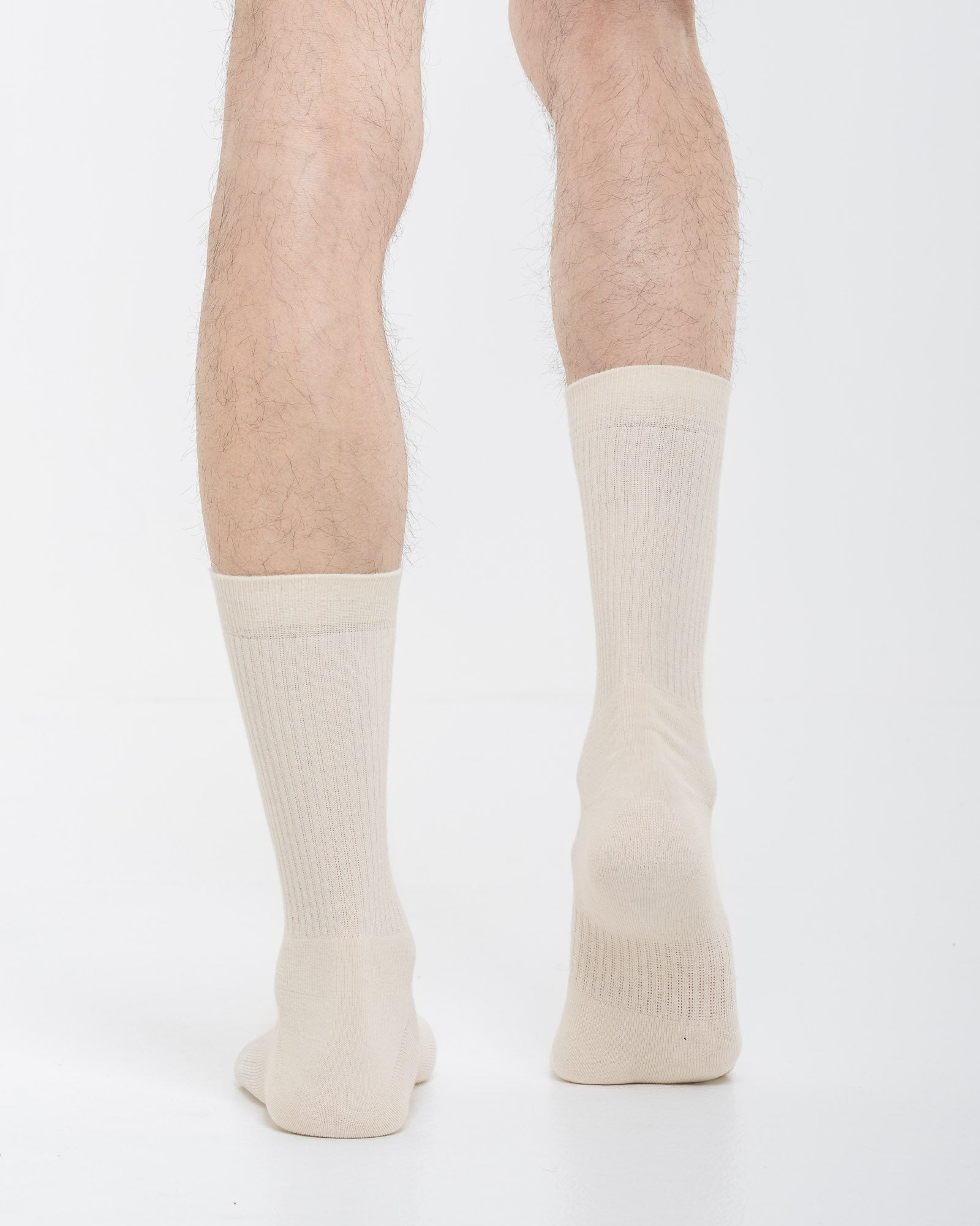 Cardo Radura Apex Half Calf socks in ecru, rear view on a model against a white background.