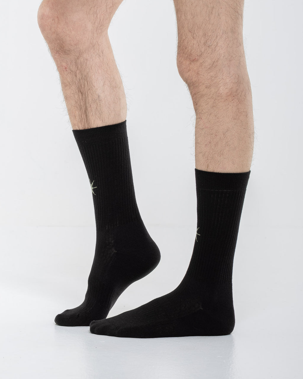 Cardo Radura Apex Half Calf socks in black, side view on a model against a white background.