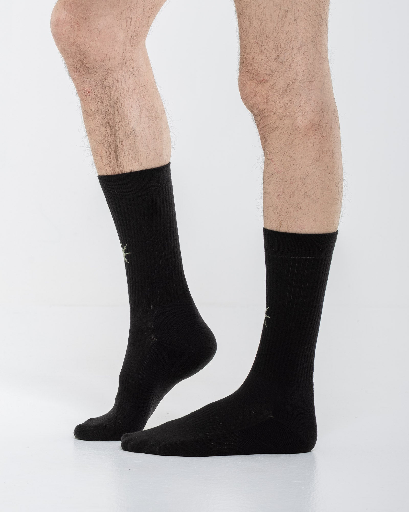 Cardo Radura Apex Half Calf socks in black, side view on a model against a white background.