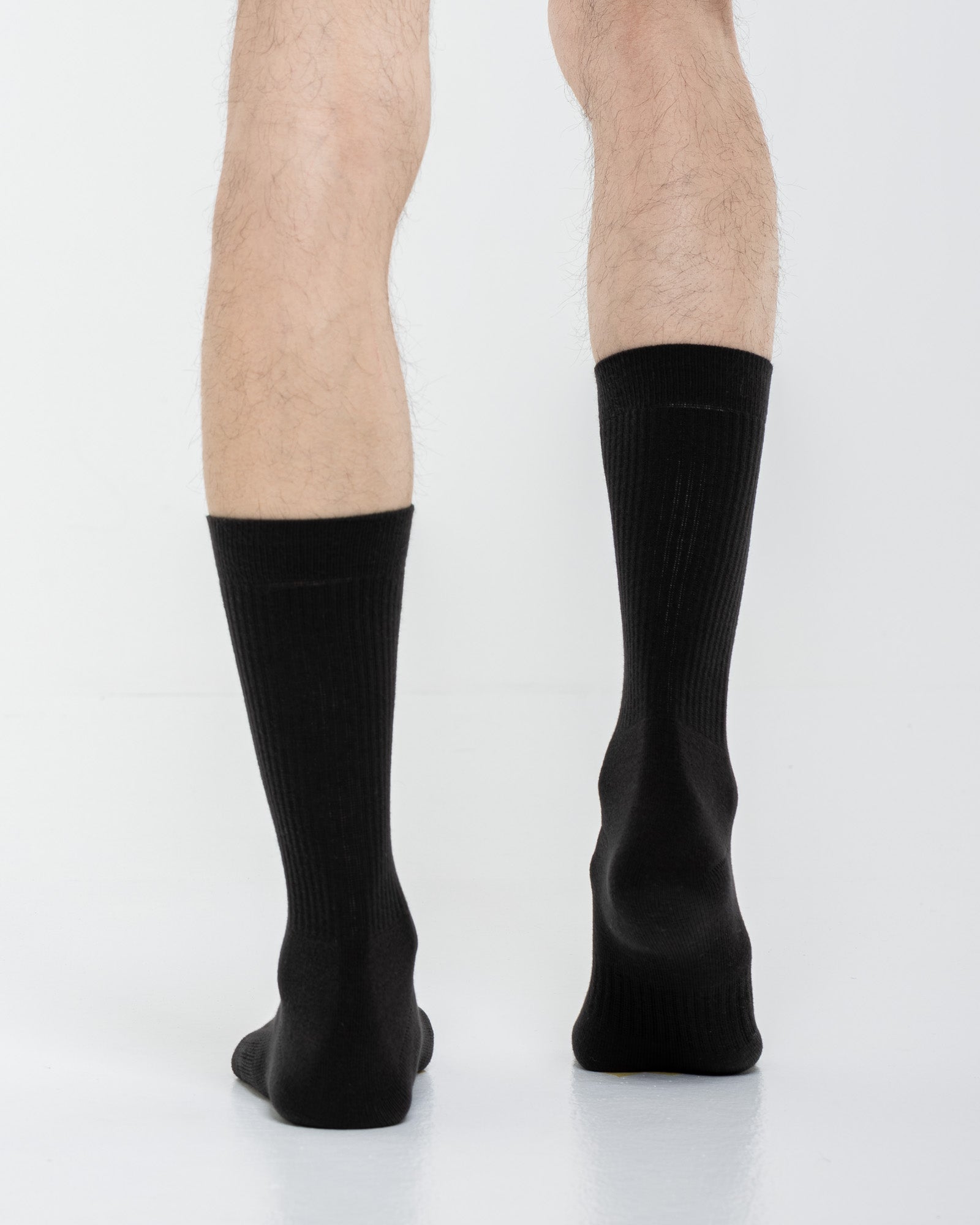 Cardo Radura Apex Half Calf socks in black, rear view on a model against a white background.