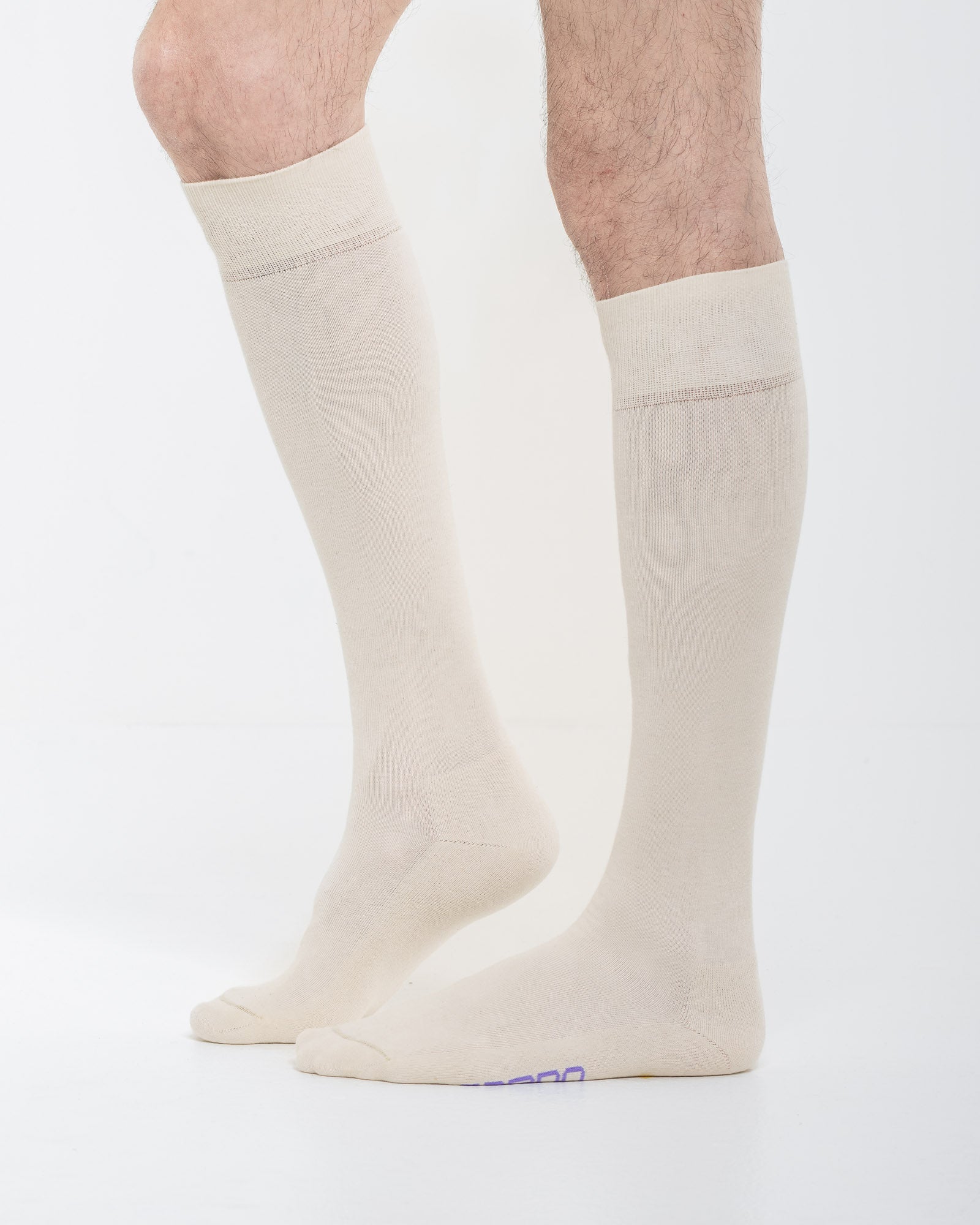 Cardo Radura Field Knee High socks in ecru, side view on a model against a white background.