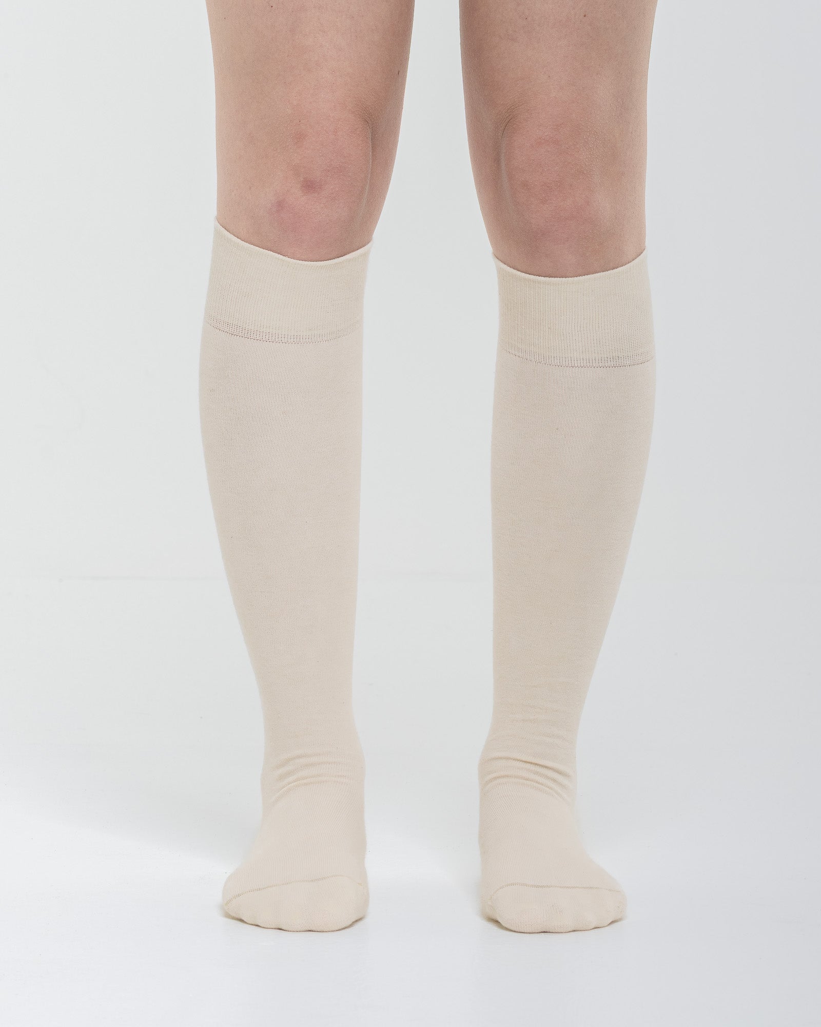 Cardo Radura Field Knee High socks in ecru, front view on a model against a white background.