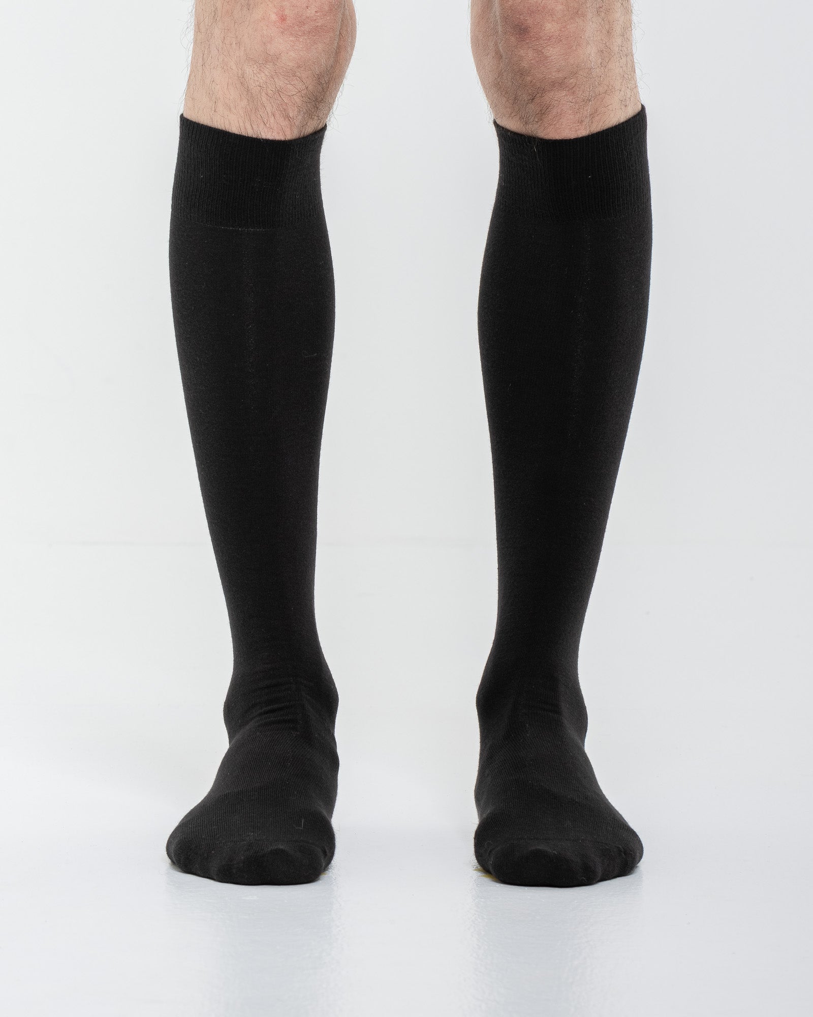 Cardo Radura Field Knee High socks in black, front view on a model against a white background.