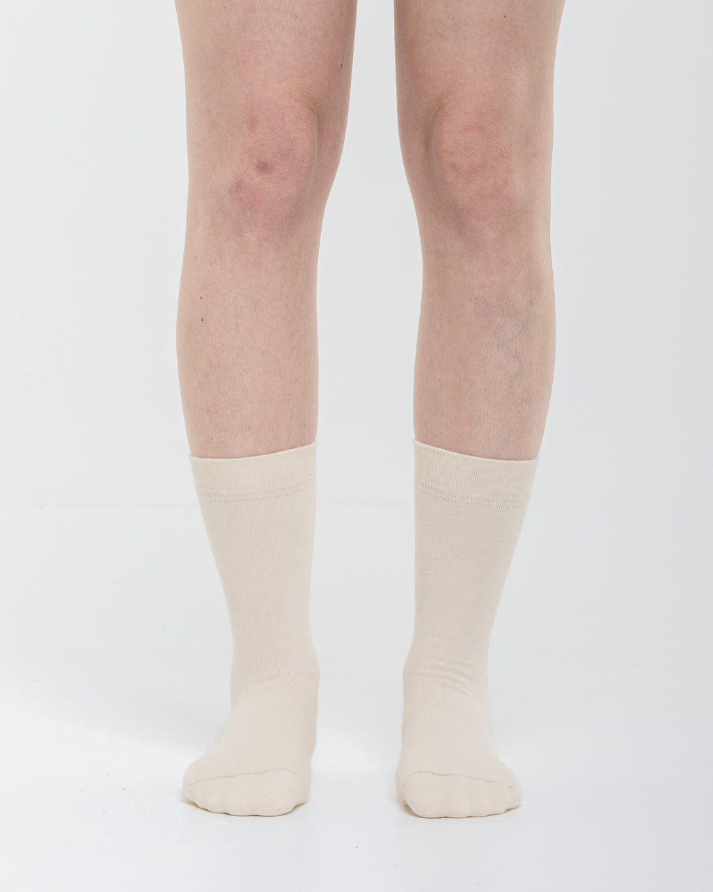 Cardo Radura Field Half Calf socks in ecru, front view on a model against a white background.