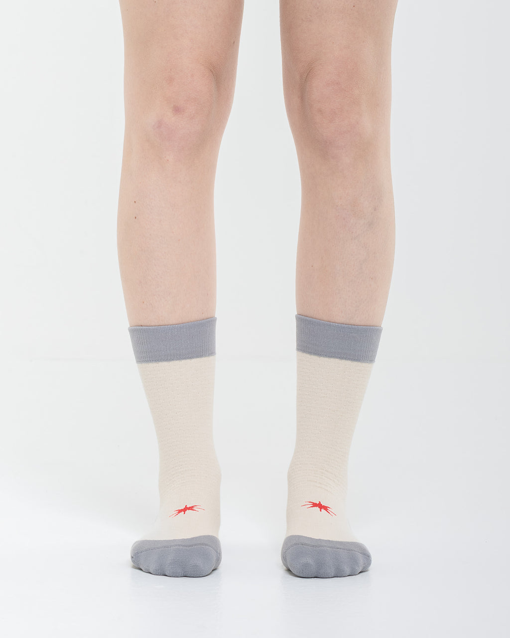Cardo Radura Strata Lite Half Calf socks in Stone, front view showing the red embroidered star detail.