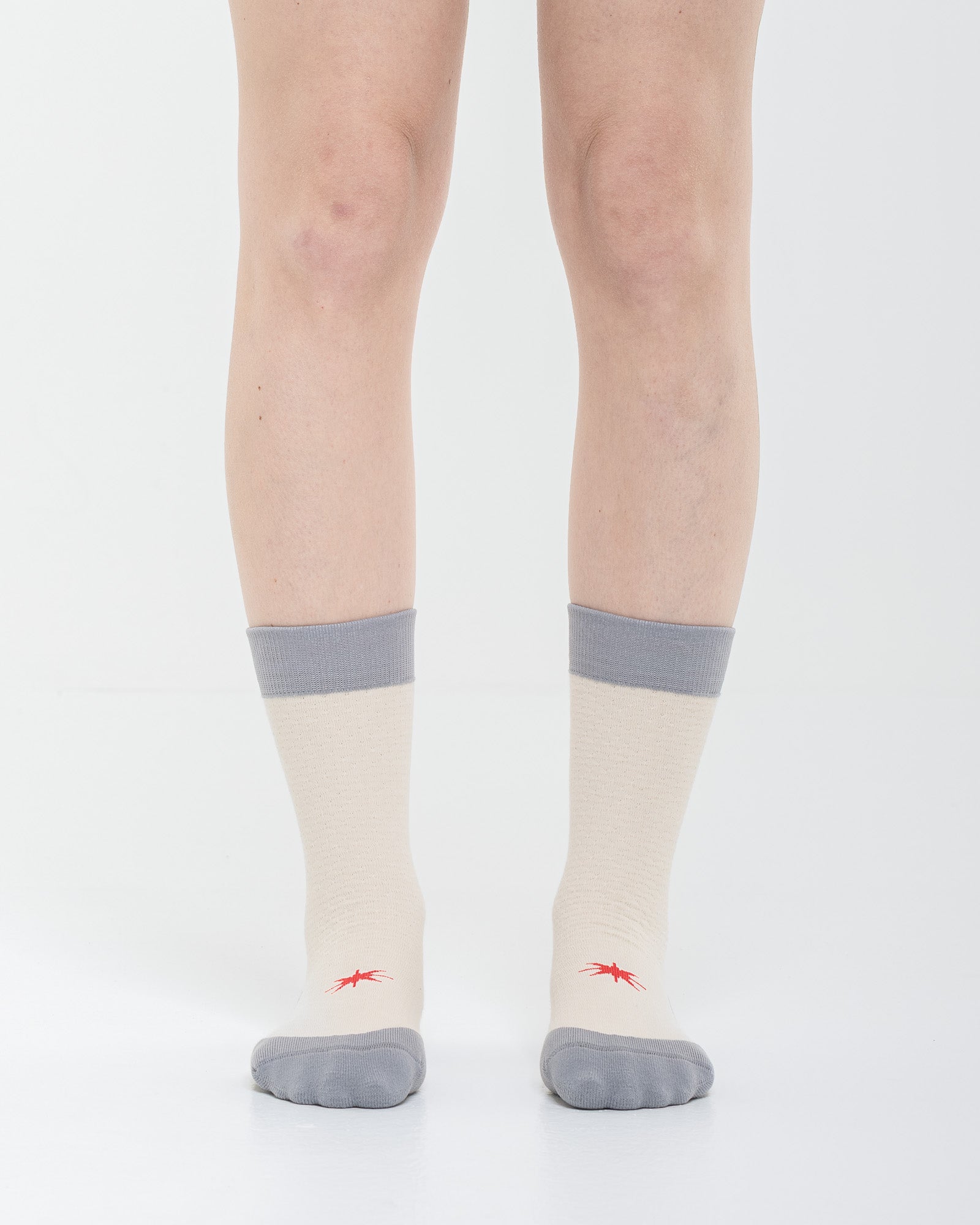 Cardo Radura Strata Lite Half Calf socks in Stone, front view showing the red embroidered star detail.