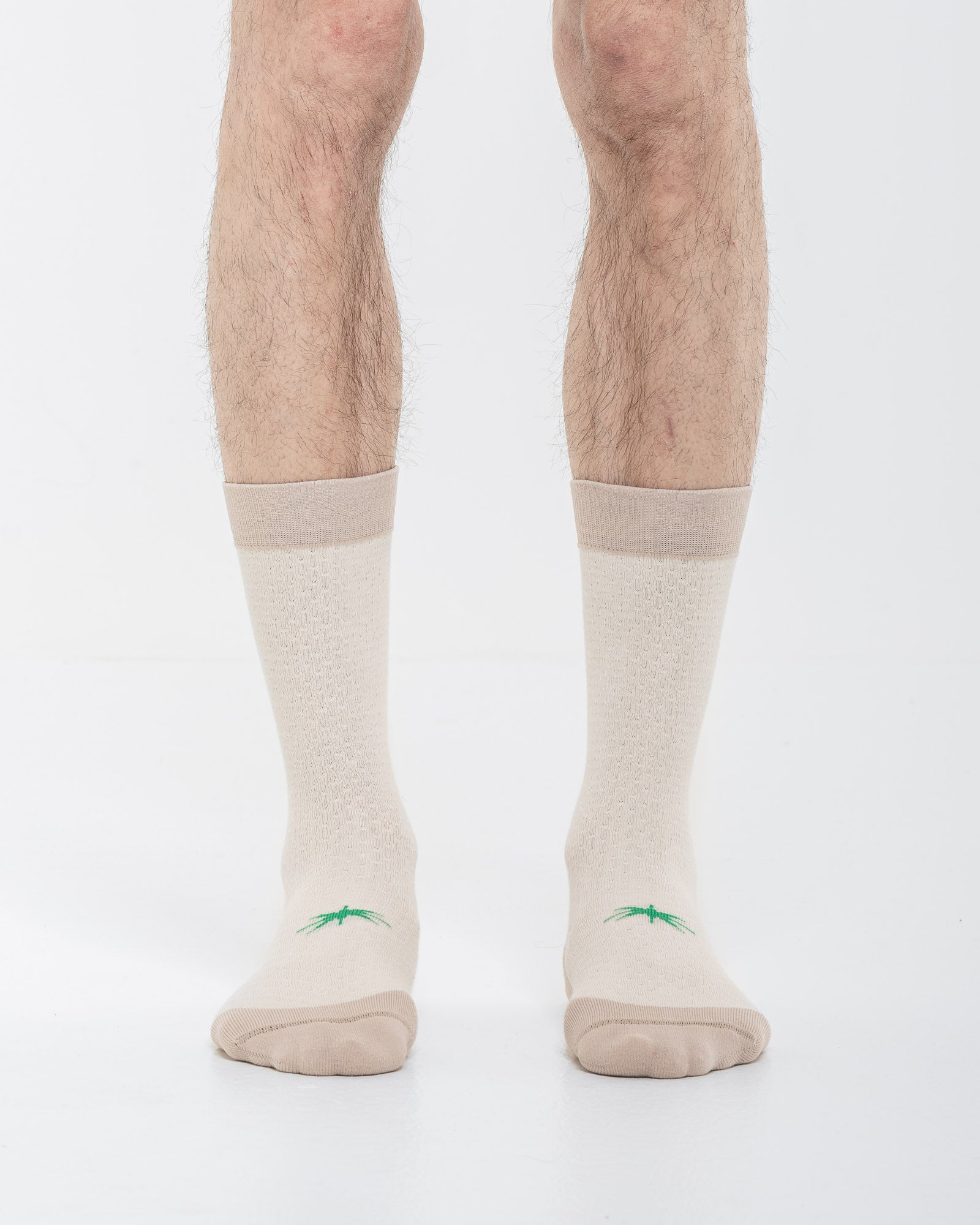 Cardo Radura Strata Lite Half Calf socks in Dove, front view showing the green embroidered star detail.