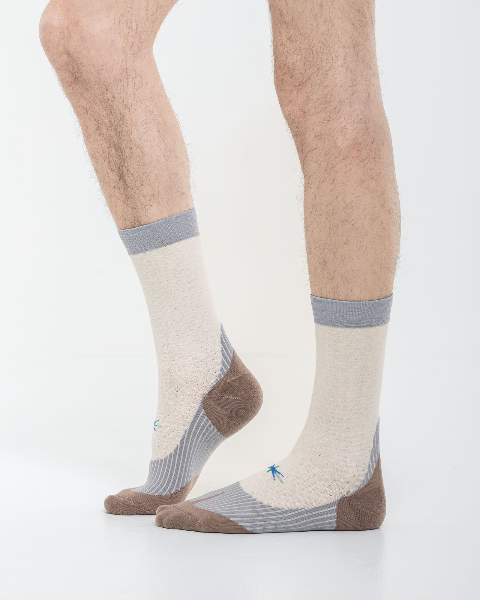 Cardo Radura Strata Half Calf socks in ecru, grey and brown, three-quarter view showing the technical knit.