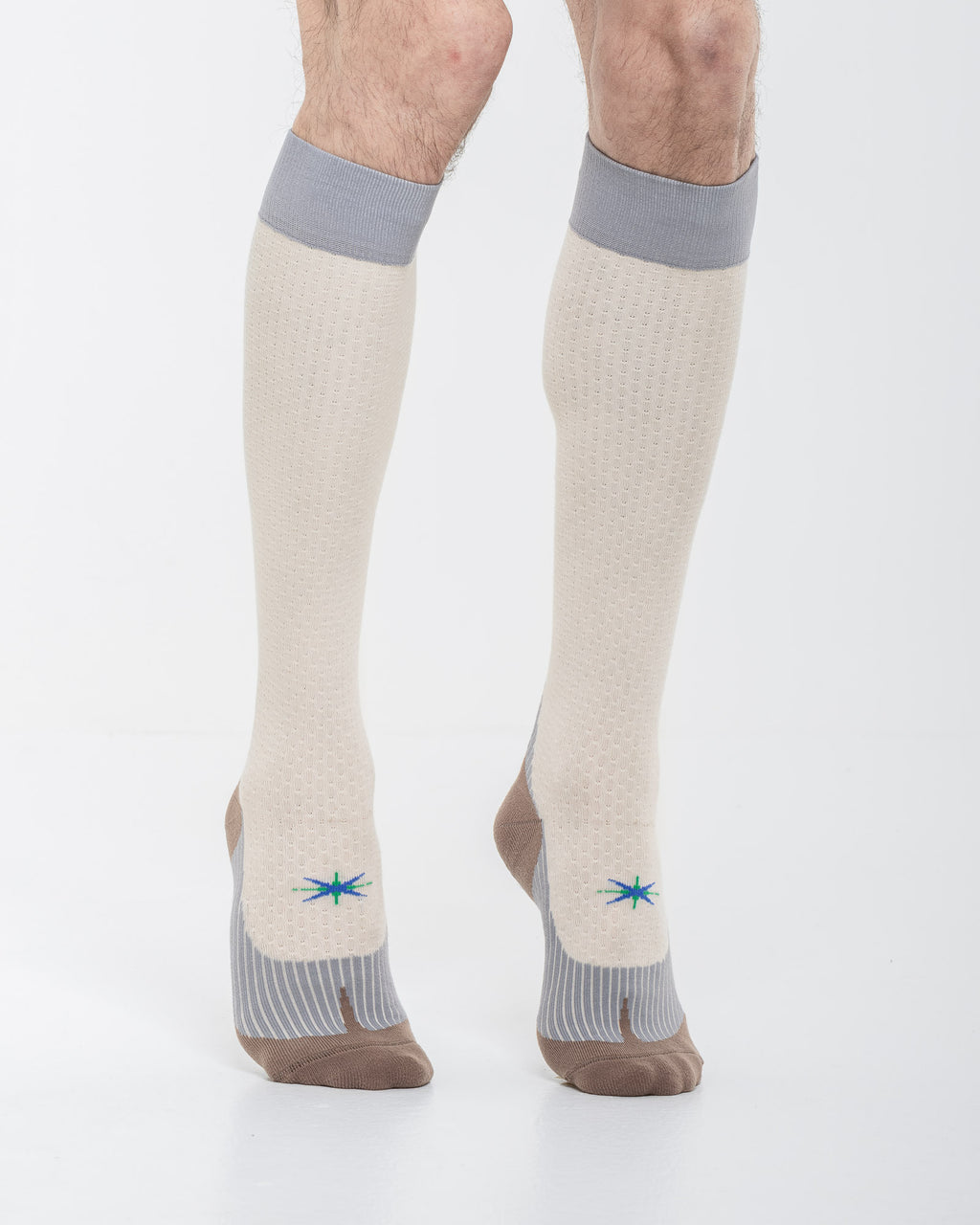 Cardo Radura Strata Knee High socks in ecru, grey and brown, three-quarter front view showing the technical knit.