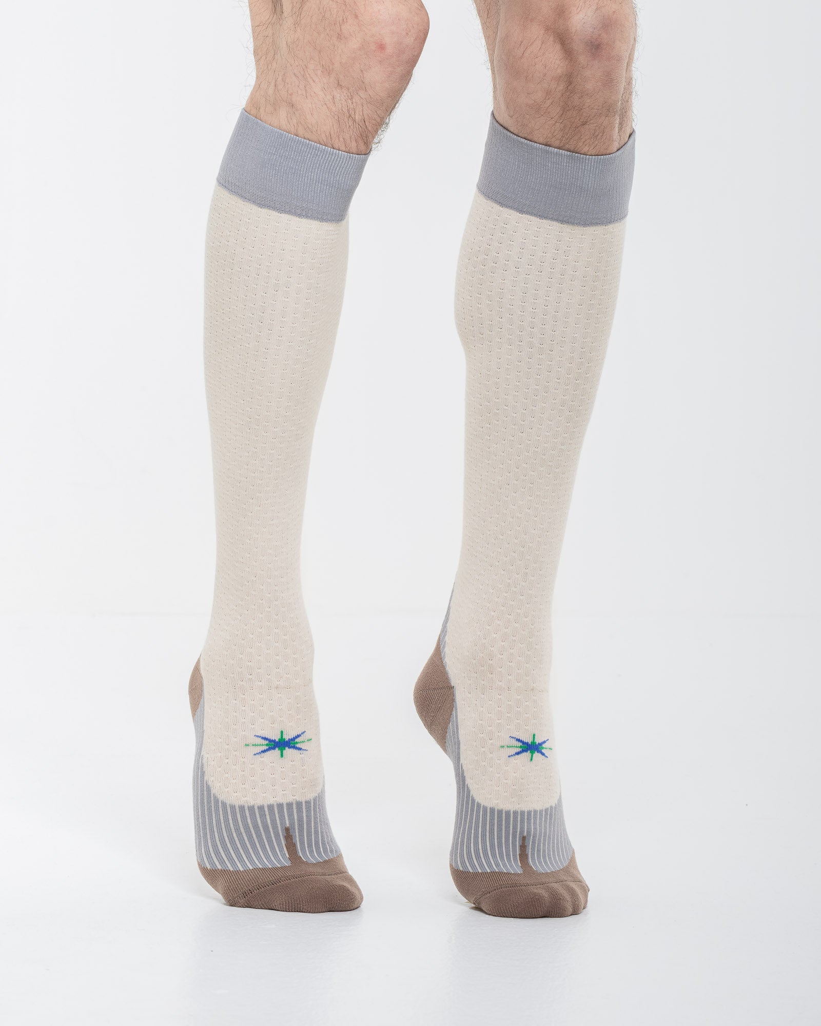 Cardo Radura Strata Knee High socks in ecru, grey and brown, three-quarter front view showing the technical knit.
